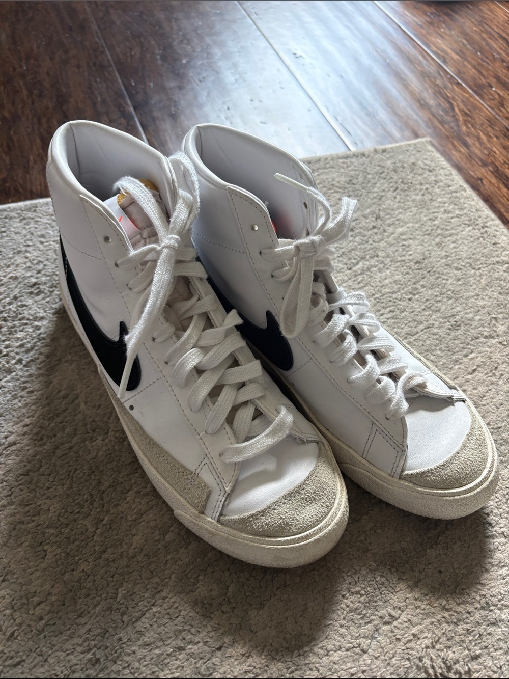 Nike White High-Top Sneakers with Black Swoosh